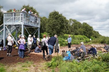 People listening to a talk given on the opening of the Neolithic trackway