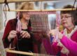 Volunteers weaving during flax workshop